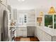 Bright kitchen features stainless appliances, white cabinets, marble countertops, and a garden window at 5 Smith St, Charleston, SC 29401