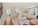 Inviting living area with hardwood floors, white sofas, and views into the dining room at 5 Smith St, Charleston, SC 29401