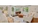 Comfortable living room with hardwood floors, a light gray rug, and large windows with sheer curtains at 5 Smith St, Charleston, SC 29401