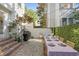 Charming brick patio with a dining table set for a meal, grill, and green privacy wall at 5 Smith St, Charleston, SC 29401