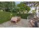 Backyard patio featuring a dining table for outdoor entertaining surrounded by green shrubs at 5 Smith St, Charleston, SC 29401