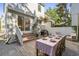 Outdoor brick patio with a dining table, grill, and access to the home, perfect for entertaining at 5 Smith St, Charleston, SC 29401