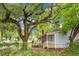 Side view of a charming single-story brick home with mature trees and a fenced yard at 5056 Piedmont Ave, North Charleston, SC 29406