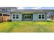 Back exterior of a home with a covered patio and a spacious green backyard at 524 Richfield Way, Summerville, SC 29486