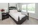 Cozy bedroom features a four-poster bed, plush carpet, and natural light from two windows at 524 Richfield Way, Summerville, SC 29486