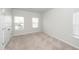 Bright bedroom featuring neutral carpet, white walls, and multiple windows for ample natural light at 524 Richfield Way, Summerville, SC 29486