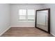 Bedroom featuring laminate flooring, a large mirror, and natural light creates a welcoming and spacious atmosphere at 524 Richfield Way, Summerville, SC 29486