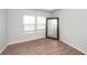 Bright bedroom with laminate floors, two windows, and a large mirror creating a modern and inviting space at 524 Richfield Way, Summerville, SC 29486