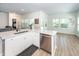 Bright kitchen boasts stainless appliances, white cabinets, quartz countertops, and access to additional rooms at 524 Richfield Way, Summerville, SC 29486