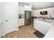 Modern kitchen features stainless appliances, white cabinets, hardwood floors and a large island at 524 Richfield Way, Summerville, SC 29486