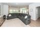 Open-concept living room with a large sectional sofa, neutral rug, and plenty of natural light at 524 Richfield Way, Summerville, SC 29486