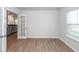 Sunlit room with laminate flooring and open french doors leading to a living space with a gray couch at 524 Richfield Way, Summerville, SC 29486