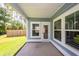 Covered patio with windows and a glass door overlooking the fenced back yard at 524 Richfield Way, Summerville, SC 29486