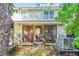 Back exterior view of home showcasing its screened porch and exterior AC units at 525 Tayrn Dr, Wando, SC 29492