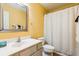 Bright, yellow bathroom with a silver-framed mirror, shower and white vanity at 525 Tayrn Dr, Wando, SC 29492