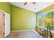 Green-painted bedroom with a large window, a ceiling fan, and neutral carpet at 525 Tayrn Dr, Wando, SC 29492