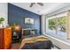 Stylish bedroom with a navy accent wall, ample natural light, and tasteful decor at 525 Tayrn Dr, Wando, SC 29492