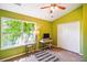 Green-painted bedroom featuring neutral carpet, ceiling fan, and a double closet at 525 Tayrn Dr, Wando, SC 29492