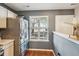 Close up of stainless steel refrigerator, window with blinds, and light wood flooring at 525 Tayrn Dr, Wando, SC 29492