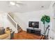 Spacious living room, hardwood floors, staircase and with entertainment center at 525 Tayrn Dr, Wando, SC 29492