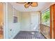 Inviting screened-in patio with ceiling fan, wood flooring, and classic design at 525 Tayrn Dr, Wando, SC 29492