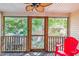 Relax on the screened porch with wooden floors, ceiling fan, and scenic backyard views at 525 Tayrn Dr, Wando, SC 29492
