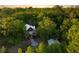 Secluded home nestled among mature trees, featuring a charming exterior with a stone pathway at 5348 Mccullough Dam Rd, Wadmalaw Island, SC 29487