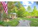 Charming backyard featuring guest house, fire pit, spacious lawn, mature trees and pond in a serene setting at 5348 Mccullough Dam Rd, Wadmalaw Island, SC 29487
