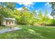 Spacious backyard featuring a guest house, gravel firepit, and a well-maintained lawn at 5348 Mccullough Dam Rd, Wadmalaw Island, SC 29487