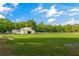 The horse barn stands in a wide-open green field, a haven for equestrian activities and animal care at 5348 Mccullough Dam Rd, Wadmalaw Island, SC 29487