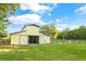 Exterior view of a well-maintained barn with a classic design, set against a backdrop of lush greenery at 5348 Mccullough Dam Rd, Wadmalaw Island, SC 29487