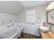 Bathroom featuring a vessel sink, wood countertop, stylish mirror, wainscoting and a soaking tub at 5348 Mccullough Dam Rd, Wadmalaw Island, SC 29487