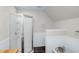 Cozy bathroom featuring a glass shower, elegant soaking tub, wainscoting, slate floors, and updated fixtures at 5348 Mccullough Dam Rd, Wadmalaw Island, SC 29487