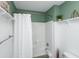 Clean bathroom features a shower with white tile, a rain shower head and wainscotting at 5348 Mccullough Dam Rd, Wadmalaw Island, SC 29487