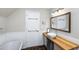 Bathroom features a vessel sink, wood countertop, stylish mirror, wainscoting and a soaking tub at 5348 Mccullough Dam Rd, Wadmalaw Island, SC 29487