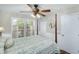 Well-lit bedroom with a four-poster bed has a ceiling fan and ample natural light at 5348 Mccullough Dam Rd, Wadmalaw Island, SC 29487