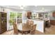 Dining area with wood table and chairs, seamlessly connecting to the kitchen for easy entertaining at 5348 Mccullough Dam Rd, Wadmalaw Island, SC 29487