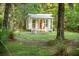 Charming exterior view of the guest house surrounded by lush greenery, offering a serene retreat at 5348 Mccullough Dam Rd, Wadmalaw Island, SC 29487