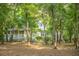 Wooded property with a home featuring a cozy front porch and surrounded by trees at 5348 Mccullough Dam Rd, Wadmalaw Island, SC 29487