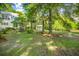Lush backyard featuring mature trees and an additional guest house, enhancing the sense of privacy at 5348 Mccullough Dam Rd, Wadmalaw Island, SC 29487