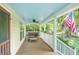 Relaxing front porch featuring cozy seating, a ceiling fan, and a classic blue ceiling at 5348 Mccullough Dam Rd, Wadmalaw Island, SC 29487