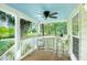 Covered porch with a classic blue ceiling, ceiling fan and a table and chairs at 5348 Mccullough Dam Rd, Wadmalaw Island, SC 29487