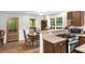 Cozy kitchen connected to the dining area, with wood cabinetry, stone countertops, and a decorative door at 5348 Mccullough Dam Rd, Wadmalaw Island, SC 29487