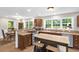 Well-lit kitchen seamlessly connected to a dining area, featuring wood cabinetry and modern appliances at 5348 Mccullough Dam Rd, Wadmalaw Island, SC 29487