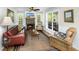Inviting living room with a fireplace, comfortable seating, and plenty of natural light from the windows at 5348 Mccullough Dam Rd, Wadmalaw Island, SC 29487
