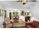 Open concept living room showcasing dining area and kitchen with abundant natural light and hardwood floors at 5348 Mccullough Dam Rd, Wadmalaw Island, SC 29487