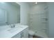 Bright bathroom featuring a vanity, toilet, and tiled-shower walls with safety bars at 602 Twin Rivers Dr, Wando, SC 29492