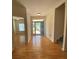 Bright foyer boasts gleaming hardwood floors, natural light, and a view of the staircase at 7517 Whispering Oak Dr, Hanahan, SC 29410