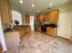 The kitchen features wooden cabinetry, stainless steel appliances, and tile flooring at 7517 Whispering Oak Dr, Hanahan, SC 29410