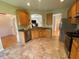 The open kitchen is equipped with stainless steel appliances and tiled flooring at 7517 Whispering Oak Dr, Hanahan, SC 29410